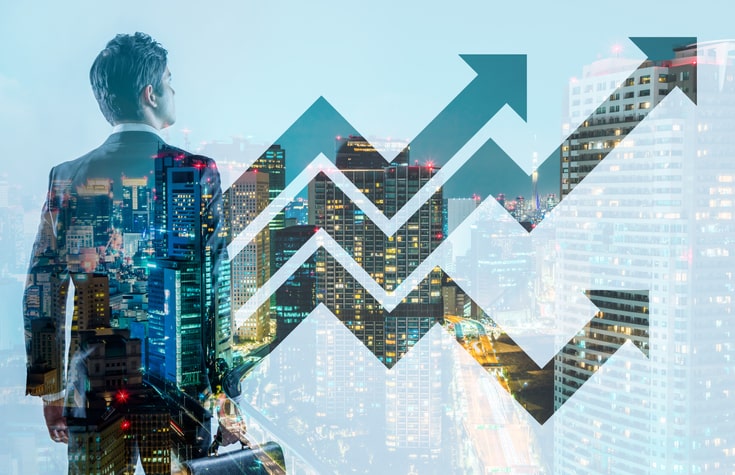 A person in a suit looks at a cityscape overlaid with upward-trending arrows, suggesting growth or progress.